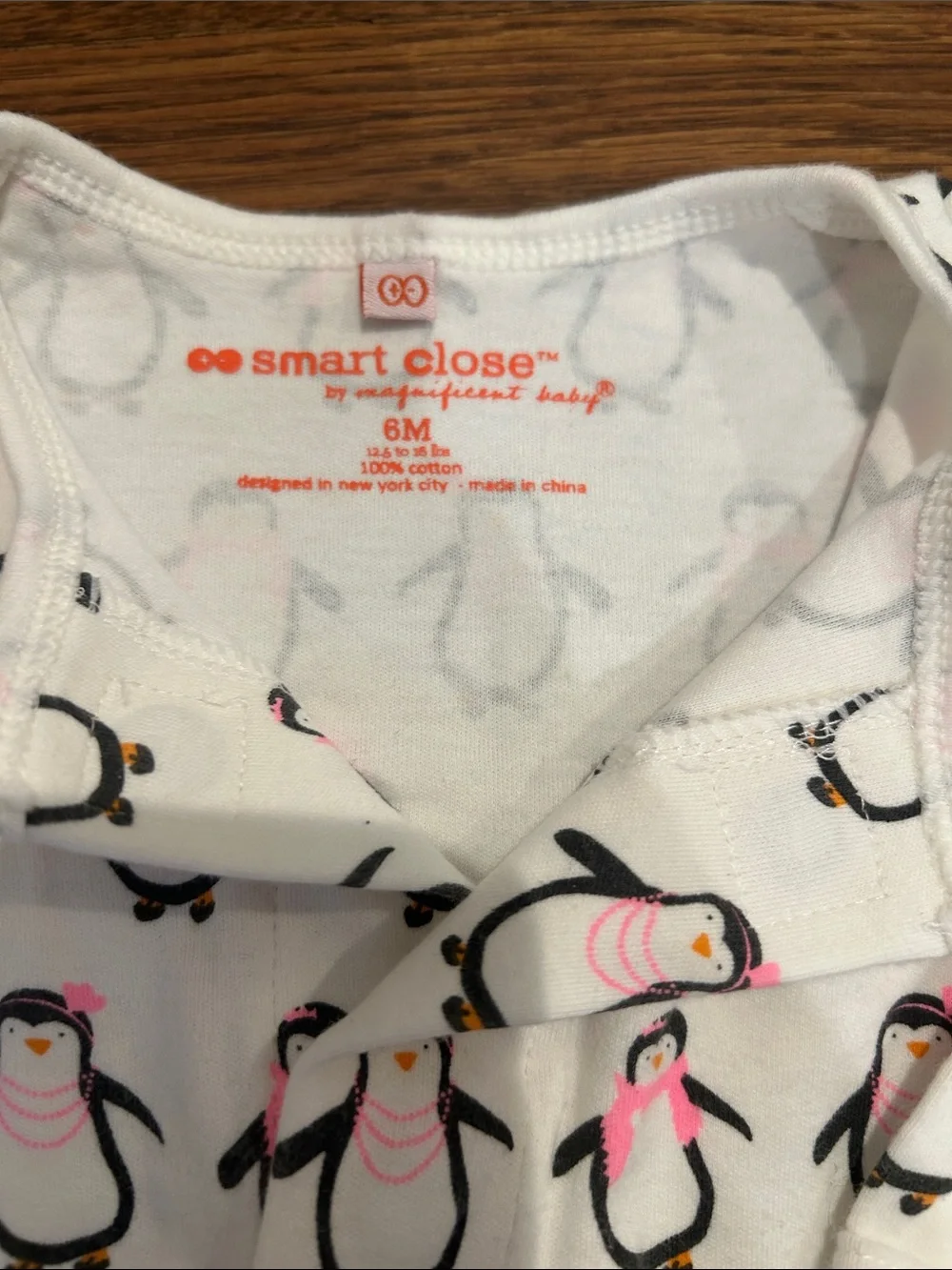 Magnificent Baby White Penguin Print One-Piece with Pink Accents